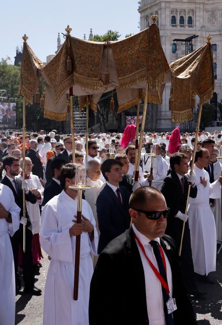 Pope Leo XIV (C) walks under a processional canopy during the Corpus Christi procession following the Holy Mass held in the Plaza de Cibeles in Madrid on June 7, 2026. Pope Leo XIV is visiting Spain June 6-12 with stops in Madrid, Barcelona, and the Canary Islands, where he will meet with migrants and organisations dedicated to helping them. (Photo by Oscar DEL POZO / AFP)