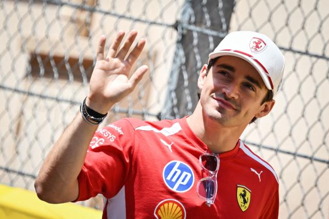 Ferrari's Monegasque driver Charles Leclerc waves as he arrives in the paddock ahead of the Monaco Formula 1 Grand Prix at the Monaco street circuit in Monaco, ahead of the, on June 7, 2026. (Photo by Andrej ISAKOVIC / AFP)
