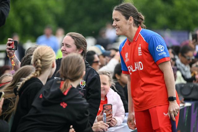 England’s Nat Sciver-Brunt (R) poses for a selfie with fams during an exhibition at The Captains' Carnival, the activation event for the ICC Women's T20 cricket world cup 2026, in central London on June 7, 2026. (Photo by JUSTIN TALLIS / AFP)