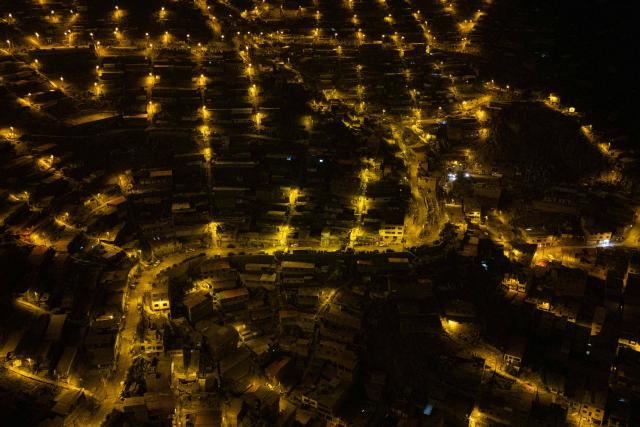 An aerial view of the San Juan de Lurigancho neighbourhood, on the northern outskirts of Lima, where Peru's presidential candidate Keiko Fujimori, for the Fuerza Popular party, will attend an election-day breakfast on June 7, 2026. (Photo by Ernesto BENAVIDES / AFP)