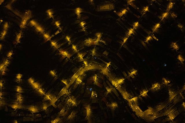 TOPSHOT - An aerial view of the San Juan de Lurigancho neighbourhood, on the northern outskirts of Lima, where Peru's presidential candidate Keiko Fujimori, for the Fuerza Popular party, will attend an election-day breakfast on June 7, 2026. (Photo by Ernesto BENAVIDES / AFP)