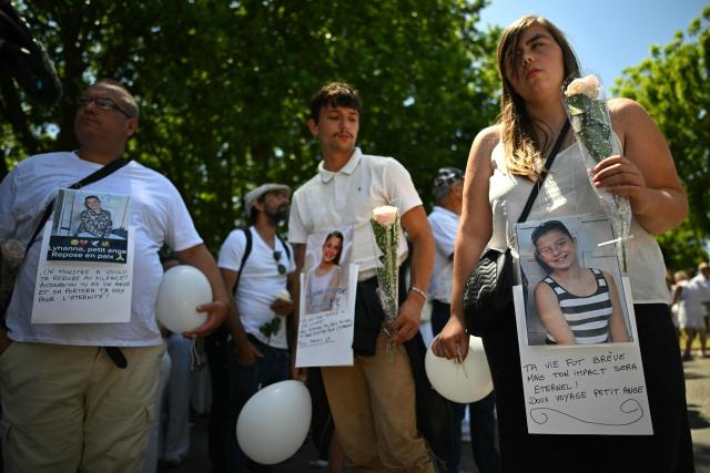 Relatives and people walk as they take part in a silent march in tribute to Lyhanna, an 11-year-old girl found dead on June 4 after having been reported missing since May 29, 2026, in Fleurance, southwestern France, on June 7, 2026. Outrage has erupted in France after it emerged the main suspect Jerome.B, a 41-year-old father of two, had been repeatedly accused of sexually abusing children but no action was taken to protect others. The placard with a photo of Lyhanna reads "Your life was short, but your impact will last forever! Rest in peace, little angel". (Photo by Lionel BONAVENTURE / AFP)