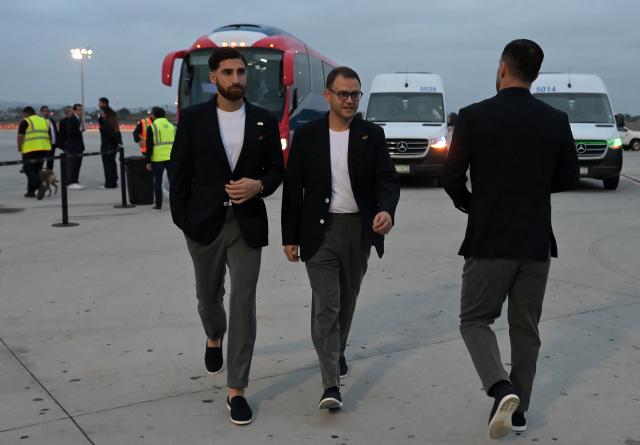 Iran's midfielder #07 Alireza Jahanbakhsh (L) walks with a media assistant on arrival at the Tijuana International Airport in Tijuana, Mexico on June 7, 2026, ahead of the FIFA 2026 World Cup football tournament. (Photo by Guillermo Arias / AFP)