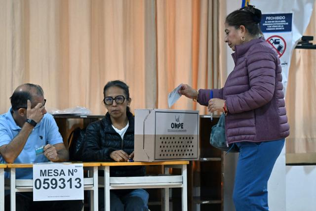 A woman casts her vote during the presidential election runoff in Lima on June 7, 2026. Peruvians will choose their ninth president in 10 years, in a tight runoff election between conservative Keiko Fujimori and leftist Roberto Sanchez who are trying to woo voters fed up with political chaos and rising crime. (Photo by MARTIN BERNETTI / AFP)