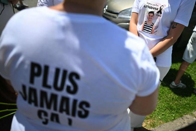Relatives and people prepare to take part in a silent march in tribute to Lyhanna, an 11-year-old girl found dead on June 4 after having been reported missing since May 29, 2026, in Fleurance, southwestern France, on June 7, 2026. Outrage has erupted in France after it emerged the main suspect Jerome.B, a 41-year-old father of two, had been repeatedly accused of sexually abusing children but no action was taken to protect others. The sticker with a photo of Lyhanna reads "Rest in peace" and the inscription on the jersey "Never again !". (Photo by Lionel BONAVENTURE / AFP)
