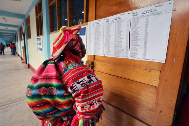 A local checks his name in an electoral roll during the presidential election runoff at a polling station in Ollantaytambo, department of Cusco, Peru, on June 7, 2026. Peruvians will choose their ninth president in 10 years in a tight runoff election between conservative Keiko Fujimori and leftist Roberto Sanchez, who are trying to woo voters fed up with political chaos and rising crime. (Photo by Jose Angulo / AFP)