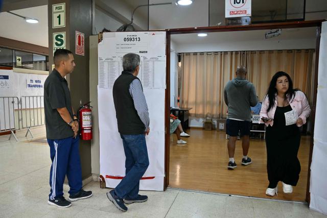 People wait to vote during the presidential election runoff in Lima on June 7, 2026. Peruvians will choose their ninth president in 10 years, in a tight runoff election between conservative Keiko Fujimori and leftist Roberto Sanchez who are trying to woo voters fed up with political chaos and rising crime. (Photo by MARTIN BERNETTI / AFP)