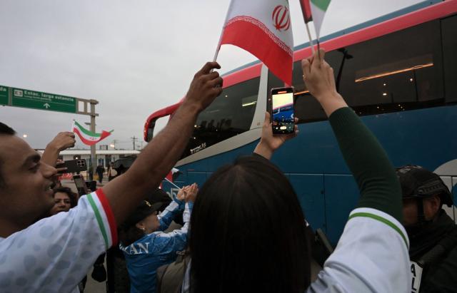 Football fans cheer as Iran's players leave the Tijuana International Airport on a bus in Tijuana, Mexico on June 7, 2026, ahead of the FIFA 2026 World Cup football tournament. (Photo by Guillermo Arias / AFP)