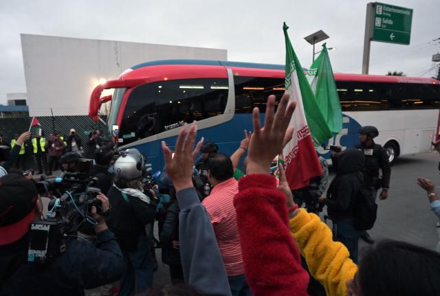 Football fans cheer as Iran's players leave the Tijuana International Airport on a bus in Tijuana, Mexico on June 7, 2026, ahead of the FIFA 2026 World Cup football tournament. (Photo by Guillermo Arias / AFP)