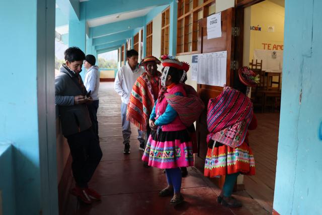 Locals wait for the polls to open during the presidential election runoff at a polling station in Ollantaytambo, department of Cusco, Peru, on June 7, 2026. Peruvians will choose their ninth president in 10 years in a tight runoff election between conservative Keiko Fujimori and leftist Roberto Sanchez, who are trying to woo voters fed up with political chaos and rising crime. (Photo by Jose Angulo / AFP)