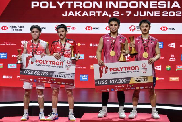 Winners Malaysia's Goh Sze Fei and Nur Izzuddin pose with runners-up Indonesia's Raymond Indra and Nikolaus Joaquin during the medal ceremony after their men's doubles final match at the Indonesia Open badminton tournament in Jakarta on June 7, 2026. (Photo by BAY ISMOYO / AFP)