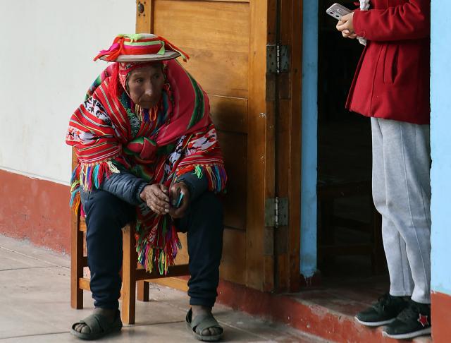 A local resident waits to vote during the presidential election runoff at a polling station in Ollantaytambo, department of Cusco, Peru, on June 7, 2026. Peruvians will choose their ninth president in 10 years in a tight runoff election between conservative Keiko Fujimori and leftist Roberto Sanchez, who are trying to woo voters fed up with political chaos and rising crime. (Photo by Jose Angulo / AFP)