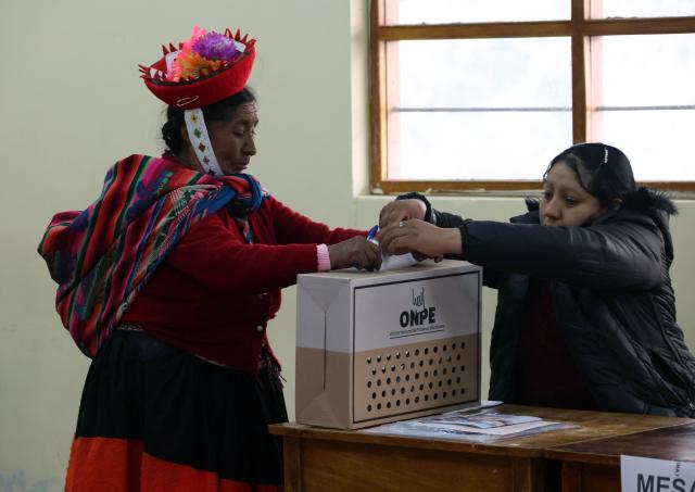 A local resident casts her vote during the presidential election runoff at a polling station in Ollantaytambo, department of Cusco, Peru, on June 7, 2026. Peruvians will choose their ninth president in 10 years in a tight runoff election between conservative Keiko Fujimori and leftist Roberto Sanchez, who are trying to woo voters fed up with political chaos and rising crime. (Photo by Jose Angulo / AFP)