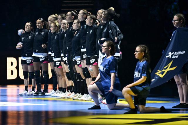 Brest Bretagne's players stand together during a ceremony prior to the EHF Women's Handball Champions League third place match between Brest Bretagne Handball and CSM Bucuresti in Budapest on June 7, 2026. (Photo by Attila KISBENEDEK / AFP)