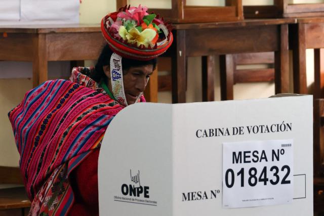 A local resident votes during the presidential election runoff at a polling station in Ollantaytambo, department of Cusco, Peru, on June 7, 2026. Peruvians will choose their ninth president in 10 years in a tight runoff election between conservative Keiko Fujimori and leftist Roberto Sanchez, who are trying to woo voters fed up with political chaos and rising crime. (Photo by Jose Angulo / AFP)