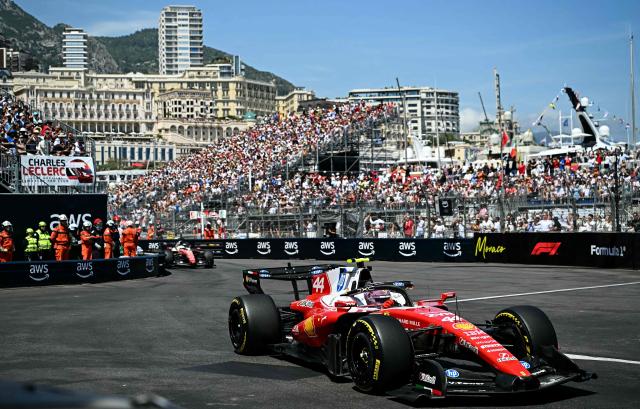 Ferrari's British driver Lewis Hamilton (R) followed by Ferrari's Monegasque driver Charles Leclerc competes during Monaco Formula 1 Grand Prix at the Monaco street circuit in Monaco, ahead of the, on June 7, 2026. (Photo by Gabriel BOUYS / AFP)