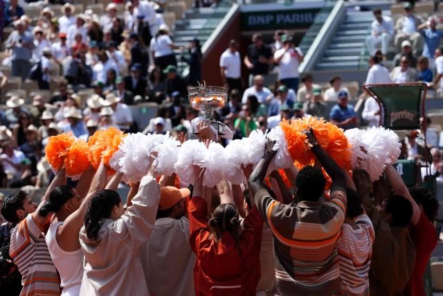 Dancers lift the Coupe des Mousquetaires (Musketeers' Trophy) as they perform during the ceremony prior to the mens final singles match on day 15 of the French Open tennis tournament on Court Philippe-Chatrier at the Roland-Garros Complex in Paris on June 7, 2026. (Photo by Dimitar DILKOFF / AFP)