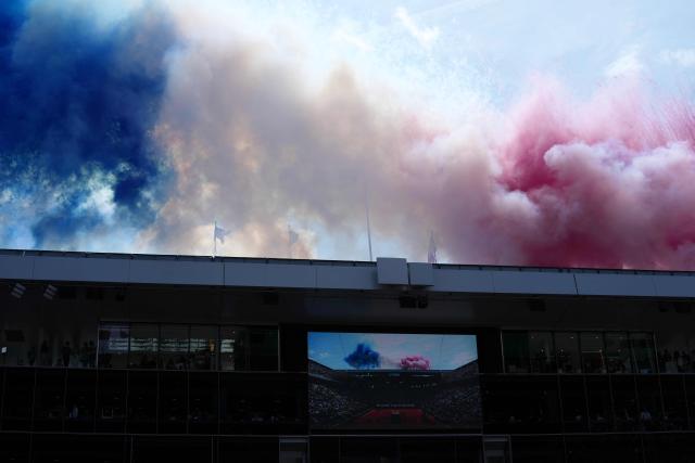 Smoke in the colours of the French flag is seen over the stadium during the ceremony prior to the mens final singles match on day 15 of the French Open tennis tournament on Court Philippe-Chatrier at the Roland-Garros Complex in Paris on June 7, 2026. (Photo by Dimitar DILKOFF / AFP)