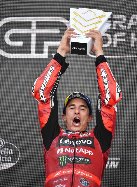 Winner Team Ducati Lenovo Team's Marc Marquez celebrates with the trophy after the Hungarian Motorcycle MotoGP Grand Prix at the Balaton Park circuit in Balatonfokajar, Hungary, on June 7, 2026. (Photo by Ferenc ISZA / AFP)