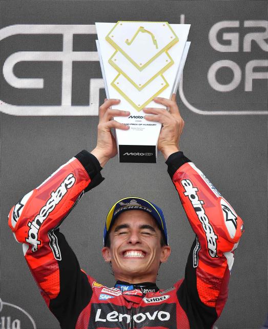Winner Team Ducati Lenovo Team's Marc Marquez celebrates with the trophy after the Hungarian Motorcycle MotoGP Grand Prix at the Balaton Park circuit in Balatonfokajar, Hungary, on June 7, 2026. (Photo by Ferenc ISZA / AFP)