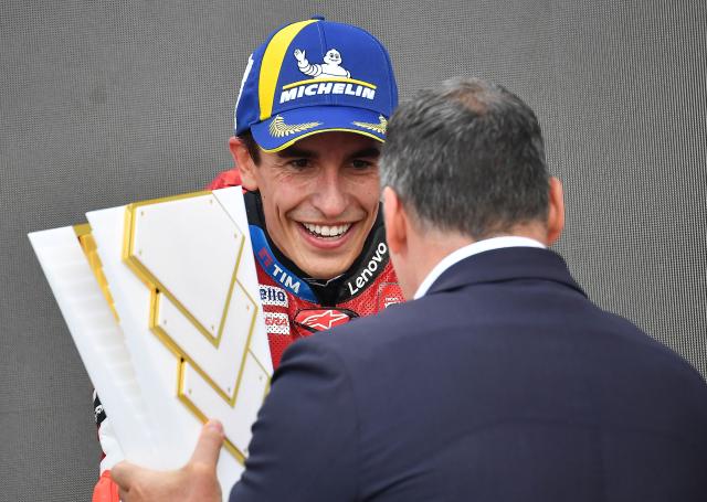 Winner Team Ducati Lenovo Team's Marc Marquez is handed the trophy after the Hungarian Motorcycle MotoGP Grand Prix at the Balaton Park circuit in Balatonfokajar, Hungary, on June 7, 2026. (Photo by Ferenc ISZA / AFP)
