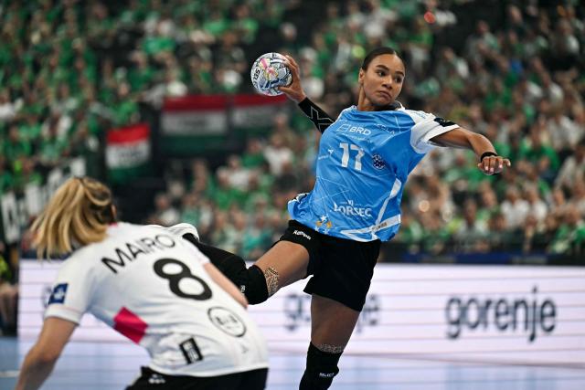 CSM Bucuresti's Slovenian centre back Elizabeth Omoregie (R) vies for the ball with Brest Bretagne's French back Clarisse Mairot during the EHF Women's Handball Champions League third place match between Brest Bretagne Handball and CSM Bucuresti in Budapest on June 7, 2026. (Photo by Attila KISBENEDEK / AFP)