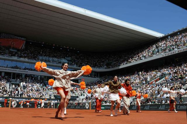 Dancers perform during the ceremony on Court Philippe-Chatrier ahead of the men's final singles match on day 15 of the French Open tennis tournament at the Roland-Garros Complex in Paris on June 7, 2026. (Photo by Thomas SAMSON / AFP)