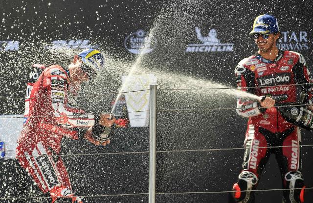 Winner Team Ducati Lenovo Team's Marc Marquez (L) and third placed Team Ducati Lenovo Team's Francesco Bagnaia celebrate with champagne on the podium of the Hungarian Motorcycle MotoGP Grand Prix at the Balaton Park circuit in Balatonfokajar, Hungary, on June 7, 2026. (Photo by Ferenc ISZA / AFP)