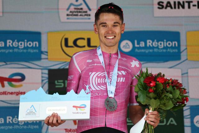 EF Education - EasyPost's French rider Alex Baudin celebrates his victory on the podium after winning the 1st stage of the Tour Auvergne-Rhone-Alpes cycling race (formerly known as the Criterium du Dauphine), 146,2km between Vizille and Saint-Ismier, in the French Alps, on June 7, 2026. (Photo by Anne-Christine POUJOULAT / AFP)