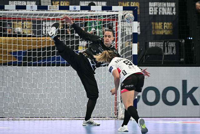 CSM Bucuresti's Brazilian goalkeeper Gabriela Moreschi blocks a shot by Brest Bretagne's French back Clarisse Mairot (R) during the EHF Women's Handball Champions League third place match between Brest Bretagne Handball and CSM Bucuresti in Budapest on June 7, 2026. (Photo by Attila KISBENEDEK / AFP)