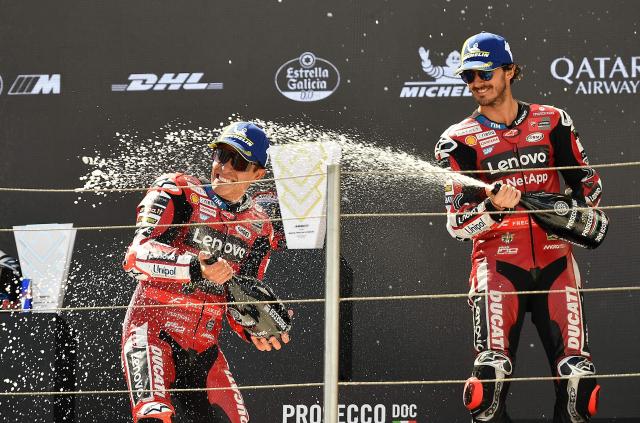 Winner Team Ducati Lenovo Team's Marc Marquez (L) and third placed Team Ducati Lenovo Team's Francesco Bagnaia celebrate with champagne on the podium of the Hungarian Motorcycle MotoGP Grand Prix at the Balaton Park circuit in Balatonfokajar, Hungary, on June 7, 2026. (Photo by Ferenc ISZA / AFP)