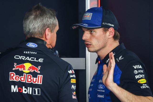 Red Bull Racing's Dutch driver Max Verstappen (R) speaks with a mechanic after taking the car back to the garage as he withdraws from the race during Monaco Formula 1 Grand Prix at the Monaco street circuit in Monaco, ahead of the, on June 7, 2026. (Photo by Yves Herman / POOL / AFP)