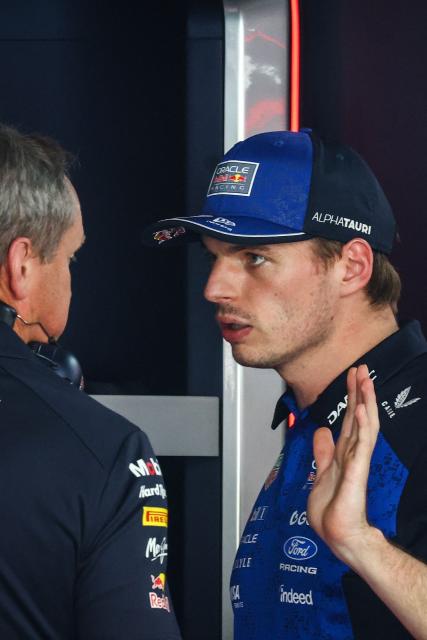 Red Bull Racing's Dutch driver Max Verstappen (R) speaks with a mechanic after taking the car back to the garage as he withdraws from the race during Monaco Formula 1 Grand Prix at the Monaco street circuit in Monaco, ahead of the, on June 7, 2026. (Photo by Yves Herman / POOL / AFP)