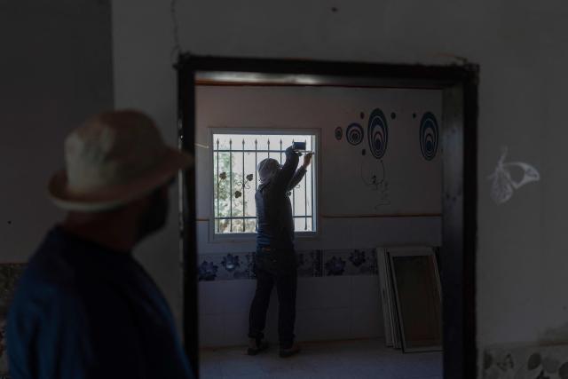 Men dismantle a house at the Bedouin community of Tel Arad, that is being self demolished ahead of a date that was given to the residents by Israeli authorities in Negev desert, in southern Israel on June 7, 2026. (Photo by Ilia YEFIMOVICH / AFP)
