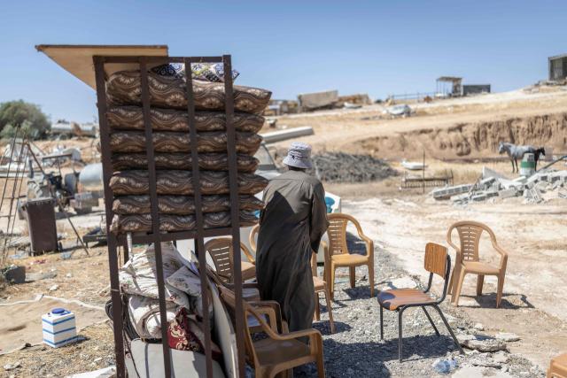An elderly man gathers his belongings at the Bedouin community of Tel Arad, that is being self demolished ahead of a date that was given to the residents by Israeli authorities in Negev desert, in southern Israel on June 7, 2026. (Photo by Ilia YEFIMOVICH / AFP)