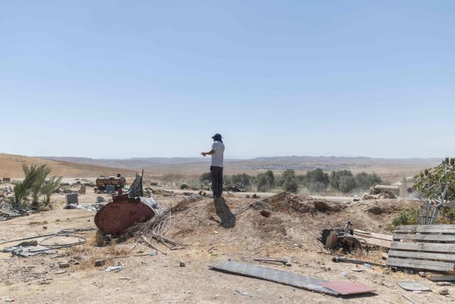 A man stands by his demolished house at the Bedouin community in Tel Arad, that is being self demolished ahead of a date that was given to the residents by Israeli authorities in Negev desert, in southern Israel on June 7, 2026. (Photo by Ilia YEFIMOVICH / AFP)