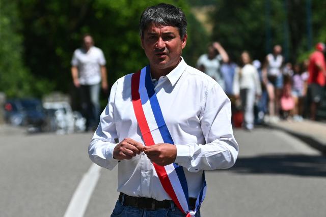 Fleurance mayor Gregory Bobbato gets ready to take part in a silent march in tribute to Lyhanna, an 11-year-old girl found dead on June 4 after having been reported missing since May 29, in Fleurance, southwestern France, on June 7, 2026. Outrage has erupted in France after it emerged the main suspect Jerome.B, a 41-year-old father of two, had been repeatedly accused of sexually abusing children but no action was taken to protect others. The inscription on the jerseys reads : "Never again !". (Photo by Lionel BONAVENTURE / AFP)