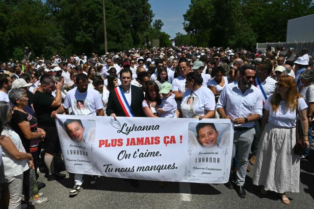 (LtoR) Lyhanna's father Martial Bernard, Fleurance mayor Gregory Bobbato and Lyhanna's mother Charly Rameau take part in a silent march in tribute to Lyhanna, an 11-year-old girl found dead on June 4 after having been reported missing since May 29, in Fleurance, southwestern France, on June 7, 2026. Outrage has erupted in France after it emerged the main suspect Jerome.B, a 41-year-old father of two, had been repeatedly accused of sexually abusing children but no action was taken to protect others. The inscription on the jerseys reads : "Never again !". (Photo by Lionel BONAVENTURE / AFP)