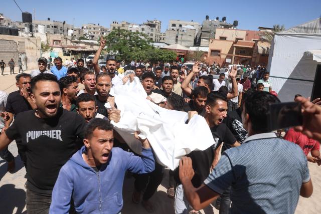 Mourners carry the body of a victim killed in a reported Israeli airstrike on a police station in the Al-Mawasi district, during a funeral at Nasser Hospital in Khan Yunis, southern Gaza Strip, on June 7, 2026. Gaza's civil defence service said an Israeli airstrike on a police station killed at least five people on June 7, and wounded several, as violence raged unabated across the Palestinian territory. Israel and Hamas continue to trade accusations of near-daily ceasefire violations, keeping the Gaza Strip locked in bloodshed months after a truce took effect in October. (Photo by Bashar Taleb / AFP)
