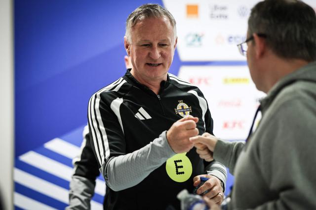 Northern Ireland's head coach Michael O'Neill greets a photographer after a press conference on the eve of the friendly football match between France and Northern Ireland ahead of the 2026 FIFA World Cup football tournament, at Stade Pierre-Mauroy in Villeneuve-d'Ascq, northern France, on June 7, 2026. (Photo by SIMON WOHLFAHRT / AFP)