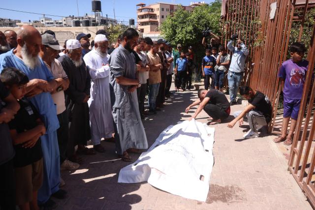 Mourners pray over the body of a victim killed in a reported Israeli airstrike on a police station in the Al-Mawasi district, during a funeral at Nasser Hospital in Khan Yunis, southern Gaza Strip, on June 7, 2026. Gaza's civil defence service said an Israeli airstrike on a police station killed at least five people on June 7, and wounded several, as violence raged unabated across the Palestinian territory. Israel and Hamas continue to trade accusations of near-daily ceasefire violations, keeping the Gaza Strip locked in bloodshed months after a truce took effect in October. (Photo by Bashar Taleb / AFP)