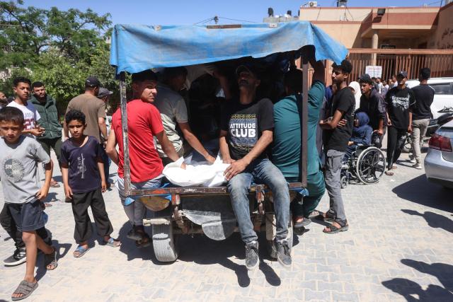 Mourners sitting in the back of a vehicle carry the body of a victim killed in a reported Israeli airstrike on a police station in the Al-Mawasi district, during a funeral at Nasser Hospital in Khan Yunis, southern Gaza Strip, on June 7, 2026. Gaza's civil defence service said an Israeli airstrike on a police station killed at least five people on June 7, and wounded several, as violence raged unabated across the Palestinian territory. Israel and Hamas continue to trade accusations of near-daily ceasefire violations, keeping the Gaza Strip locked in bloodshed months after a truce took effect in October. (Photo by Bashar Taleb / AFP)