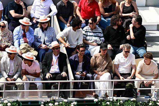 French actor Pierre Niney (Bottom Centre), French actress Adele Exarchopoulos (2nd Row 3R) and French director and actor Guillaume Canet (bottom 2R) watch Germany's Alexander Zverev playing against Italy's Flavio Cobolli during their mens final singles match on day 15 of the French Open tennis tournament on Court Philippe-Chatrier at the Roland-Garros Complex in Paris on June 7, 2026. (Photo by JULIEN DE ROSA / AFP)