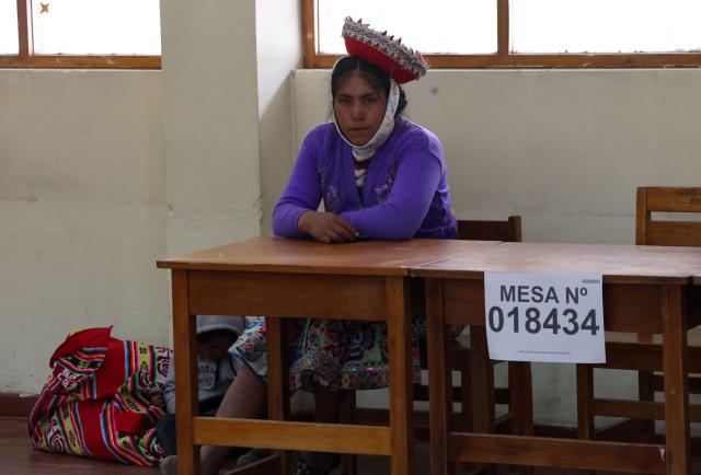 An election staffer sits at a polling station during the presidential election runoff in Ollantaytambo, department of Cusco, Peru, on June 7, 2026. Peruvians will choose their ninth president in 10 years in a tight runoff election between conservative Keiko Fujimori and leftist Roberto Sanchez, who are trying to woo voters fed up with political chaos and rising crime. (Photo by Jose Angulo / AFP)