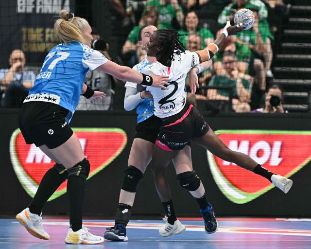 Brest Bretagne's French centre back Meline Nocandy (R) vies for the ball with CSM Bucuresti's Montenegrin left back Djurdjina Jaukovic (C hidden) and CSM Bucuresti's Romanian line player Crina Elena Pintea during the EHF Women's Handball Champions League third place match between Brest Bretagne Handball and CSM Bucuresti in Budapest on June 7, 2026. (Photo by Attila KISBENEDEK / AFP)