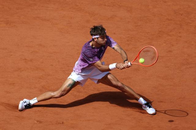 Italy's Flavio Cobolli plays a backhand return to Germany's Alexander Zverev during their men's final singles match on day 15 of the French Open tennis tournament on Court Philippe-Chatrier at the Roland-Garros Complex in Paris on June 7, 2026. (Photo by Alain JOCARD / AFP)