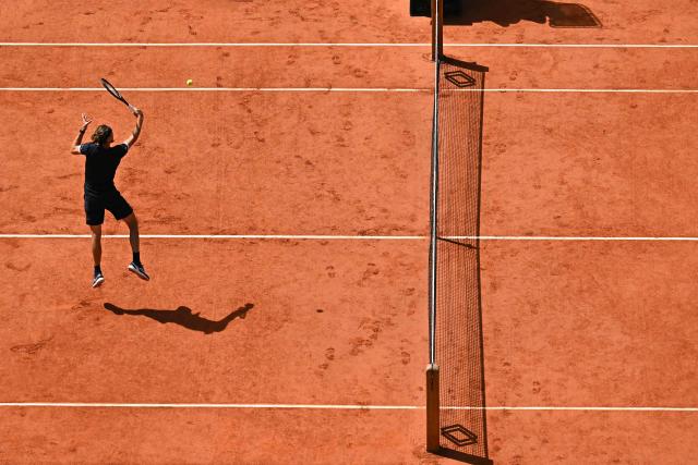 Germany's Alexander Zverev jumps to play a backhand volley to Italy's Flavio Cobolli during their men's final singles match on day 15 of the French Open tennis tournament on Court Philippe-Chatrier at the Roland-Garros Complex in Paris on June 7, 2026. (Photo by JULIEN DE ROSA / AFP)