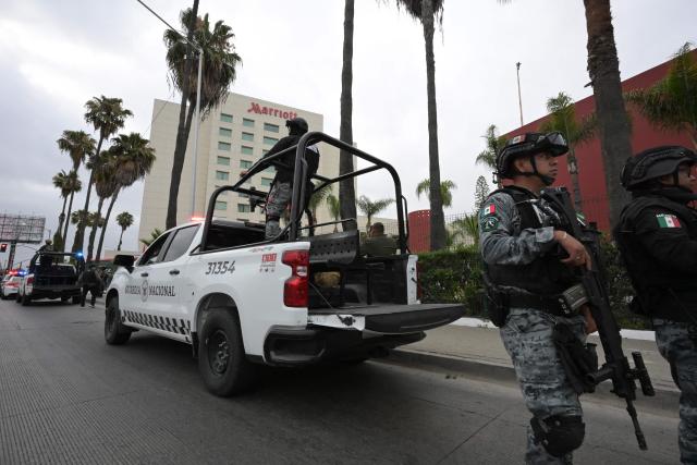 National Guard officers stand guard outside the hotel where Iran's players are staying following their arrival in Tijuana, Mexico, on June 7, 2026, ahead of the FIFA 2026 World Cup football tournament. (Photo by Guillermo Arias / AFP)