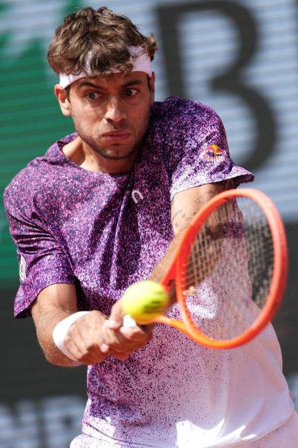 Italy's Flavio Cobolli plays a backhand return to Germany's Alexander Zverev during their mens final singles match on day 15 of the French Open tennis tournament on Court Philippe-Chatrier at the Roland-Garros Complex in Paris on June 7, 2026. (Photo by Dimitar DILKOFF / AFP)