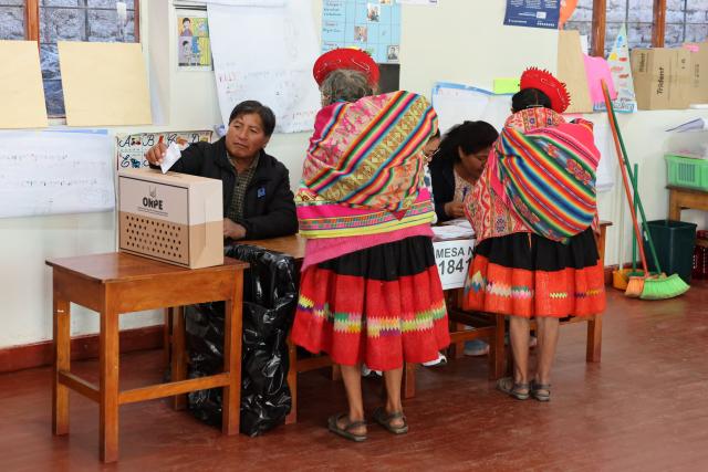 TOPSHOT - Local residents prepare to cast their vote during the presidential election runoff at a polling station in Ollantaytambo, department of Cusco, Peru, on June 7, 2026. Peruvians will choose their ninth president in 10 years in a tight runoff election between conservative Keiko Fujimori and leftist Roberto Sanchez, who are trying to woo voters fed up with political chaos and rising crime. (Photo by Jose Angulo / AFP)
